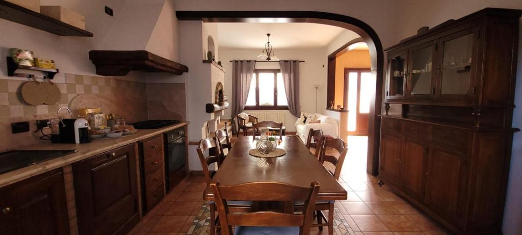 a kitchen with a table and chairs in a room at Delta Liberty BnB in Codigoro