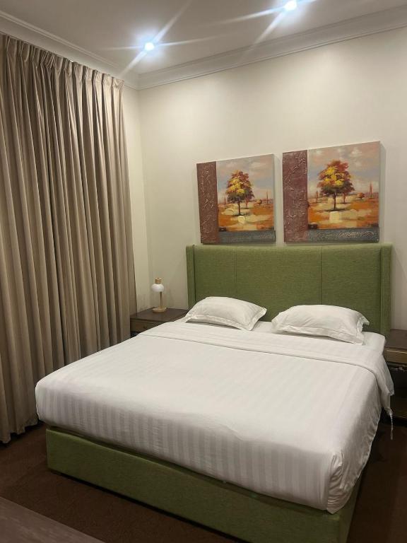 Postel nebo postele na pokoji v ubytování Aseel Hotel Apartment