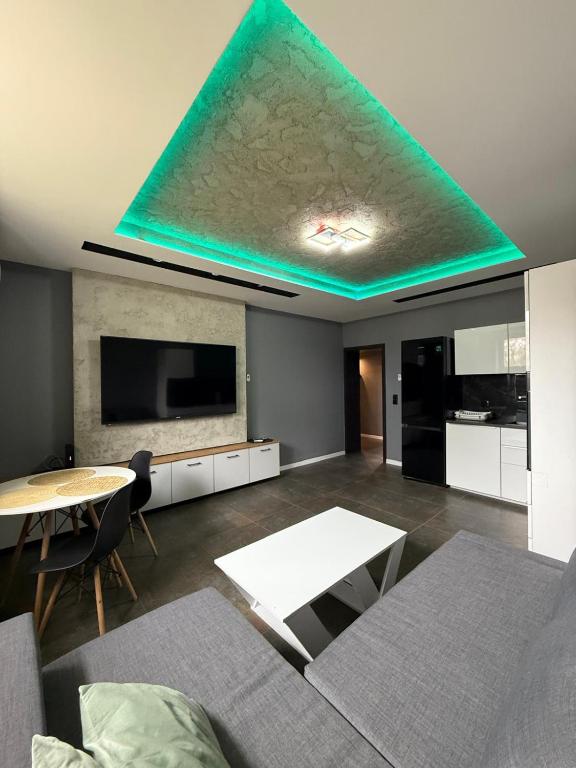 a living room with a ceiling with a blue light at Apartament Centrum 3-pokojowy Klimatyzacja nr 4 in Radom
