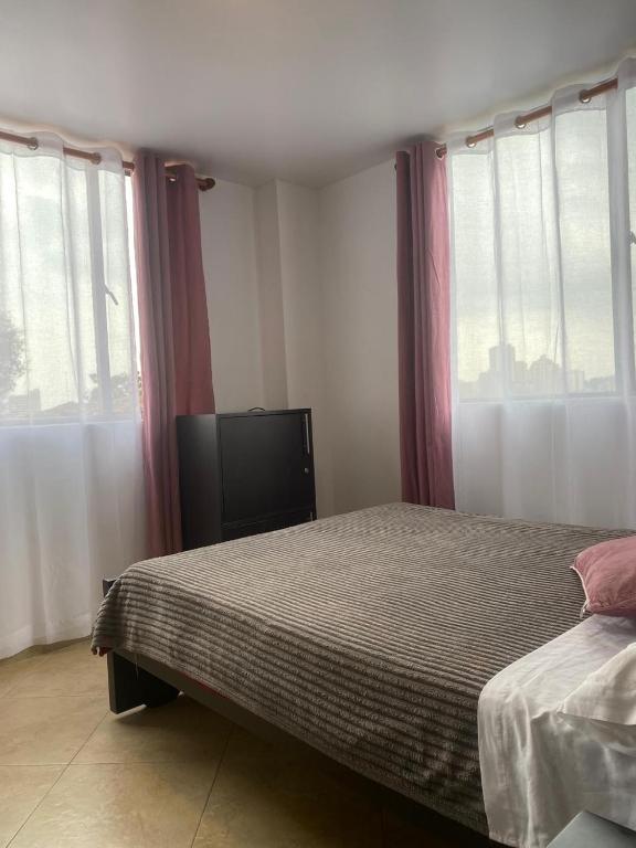Postel nebo postele na pokoji v ubytování Destino Nómada Calle 11 n 1-38