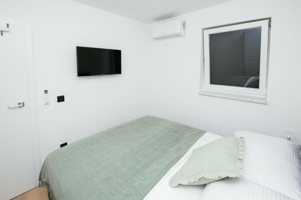 Posteľ alebo postele v izbe v ubytovaní DiDixi Apartments