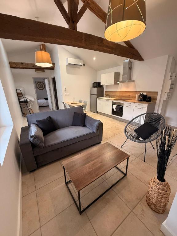 a living room with a couch and a coffee table at Saint Amour Appartement T2 in Lancié