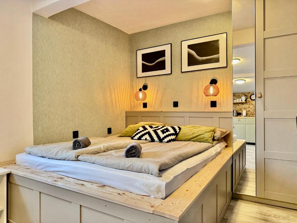 a bedroom with a large bed on a wooden platform at Monte Poddasze I Ciasna ale wanna I 5 minut plaża in Sopot