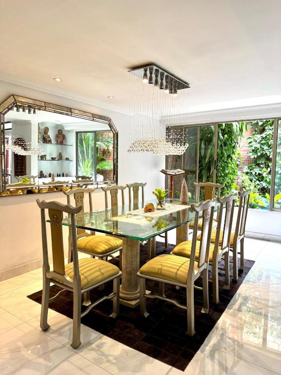 a dining room with a table and chairs at House surrounded by nature in Cali