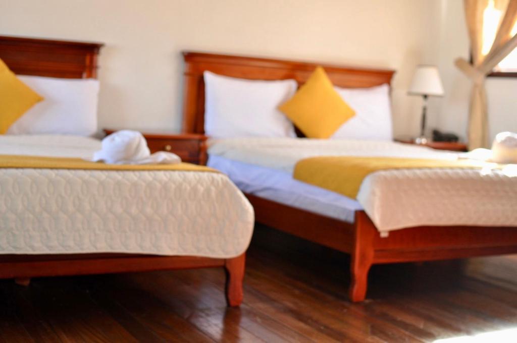 Postel nebo postele na pokoji v ubytování Hotel Coronel