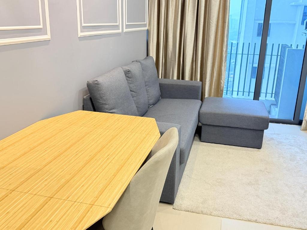 a living room with a couch and a table at Colony Service Suites Kuala Lumpur in Kuala Lumpur