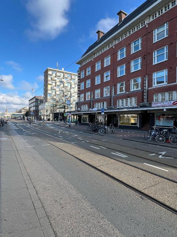 an empty street in front of a brick building at Amigo Hotel in Amsterdam