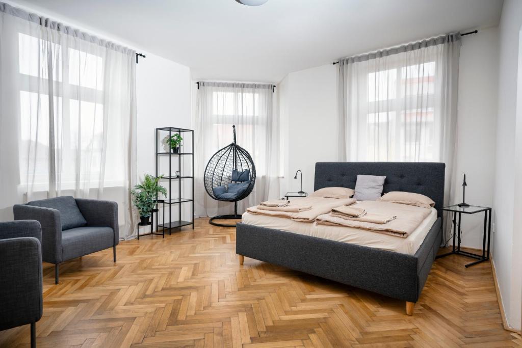 a bedroom with a bed and a chair at Apartmán náměstí Františka Křižíka in Tábor