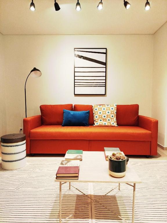 a living room with a red couch and a coffee table at Douro Valley View Apartments in Armamar