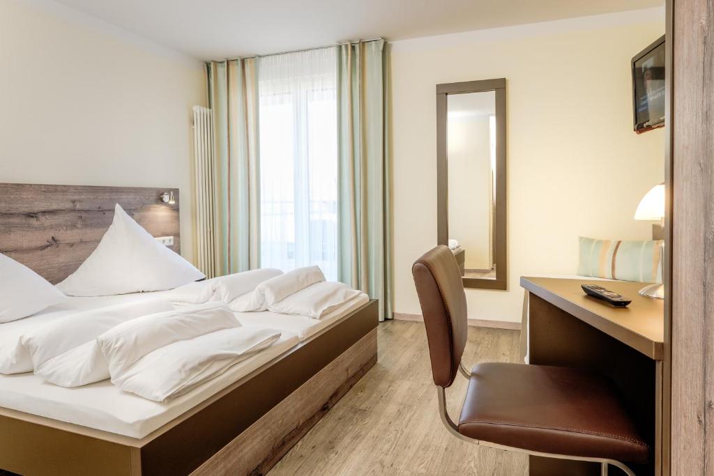 Postel nebo postele na pokoji v ubytování Hotel Mythos