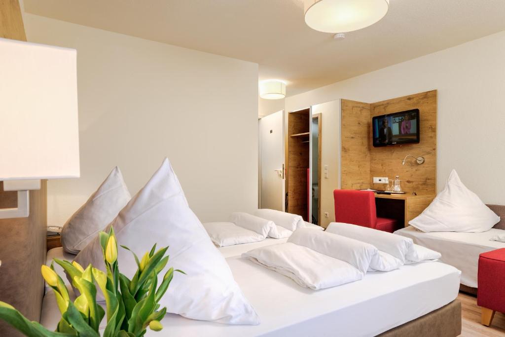 Postel nebo postele na pokoji v ubytování Hotel Mythos
