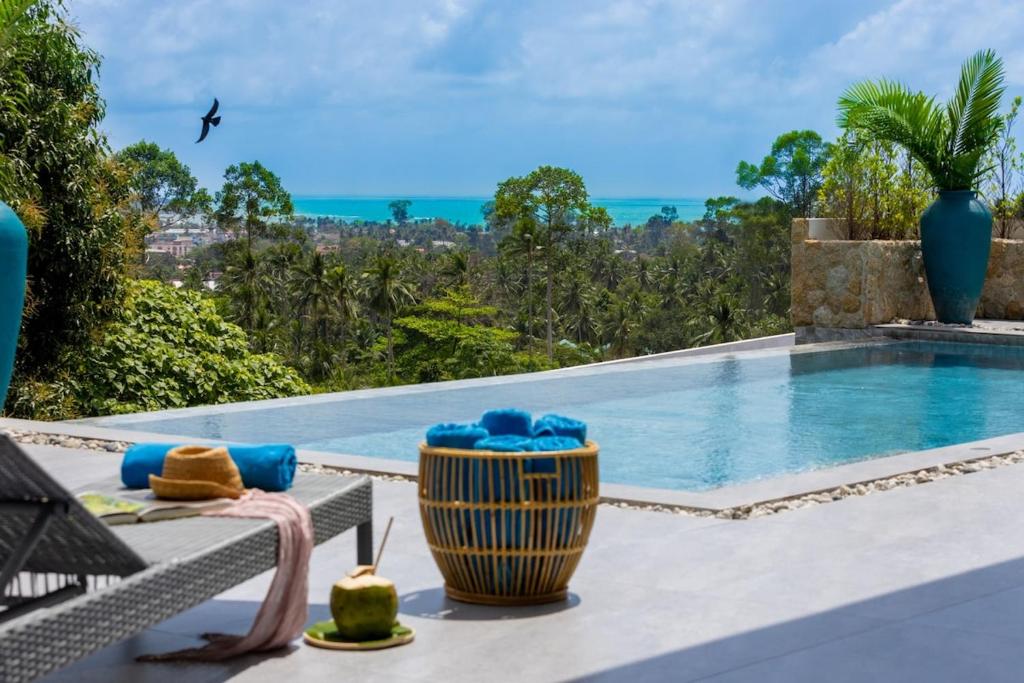 a view of a swimming pool from a villa at VILLA CAMILLE - SEAVIEW - 4 Bedrooms in Koh Samui 