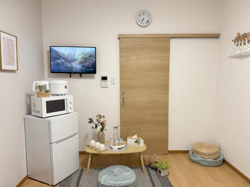 a kitchen with a white refrigerator and a microwave at 58 池袋駅 7分 2-4人丨Ikebukuro 7 minutes 2-4 people in Tokyo