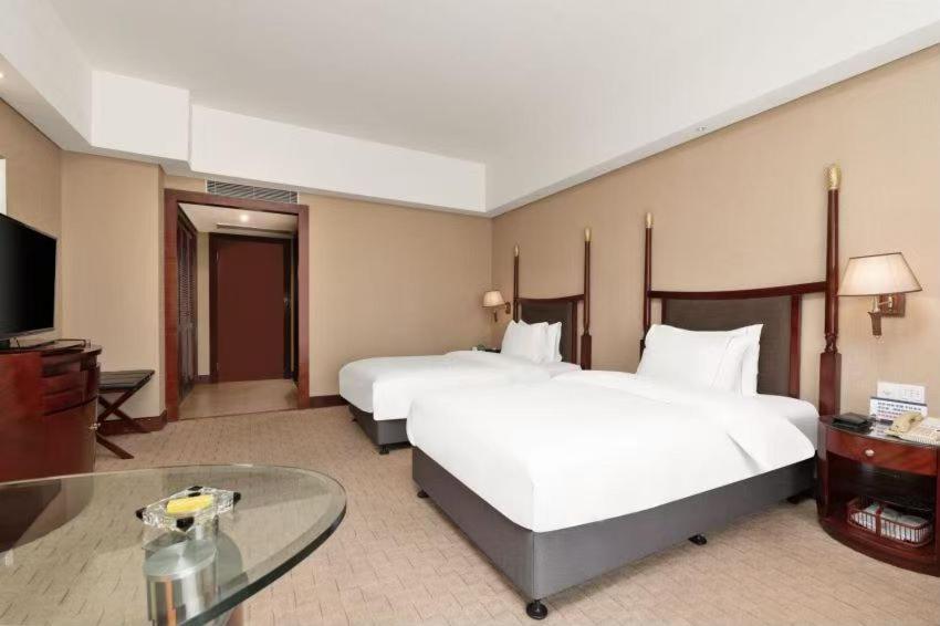 Postel nebo postele na pokoji v ubytování 深圳国际会展中心凯嘉酒店-Shenzhen Kaijia Hotel-Shenzhen-World
