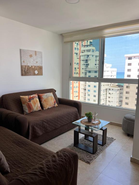 a living room with a couch and a table at Suite vista al Mar Salinas in Salinas