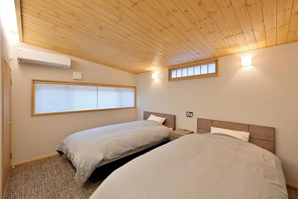 Postel nebo postele na pokoji v ubytování Shikinosato Hanamura