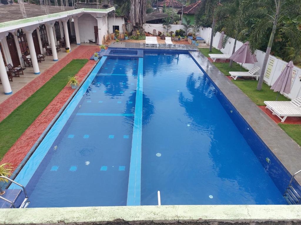 an overhead view of a swimming pool with blue water at MRD Beach Hotel in Trincomalee
