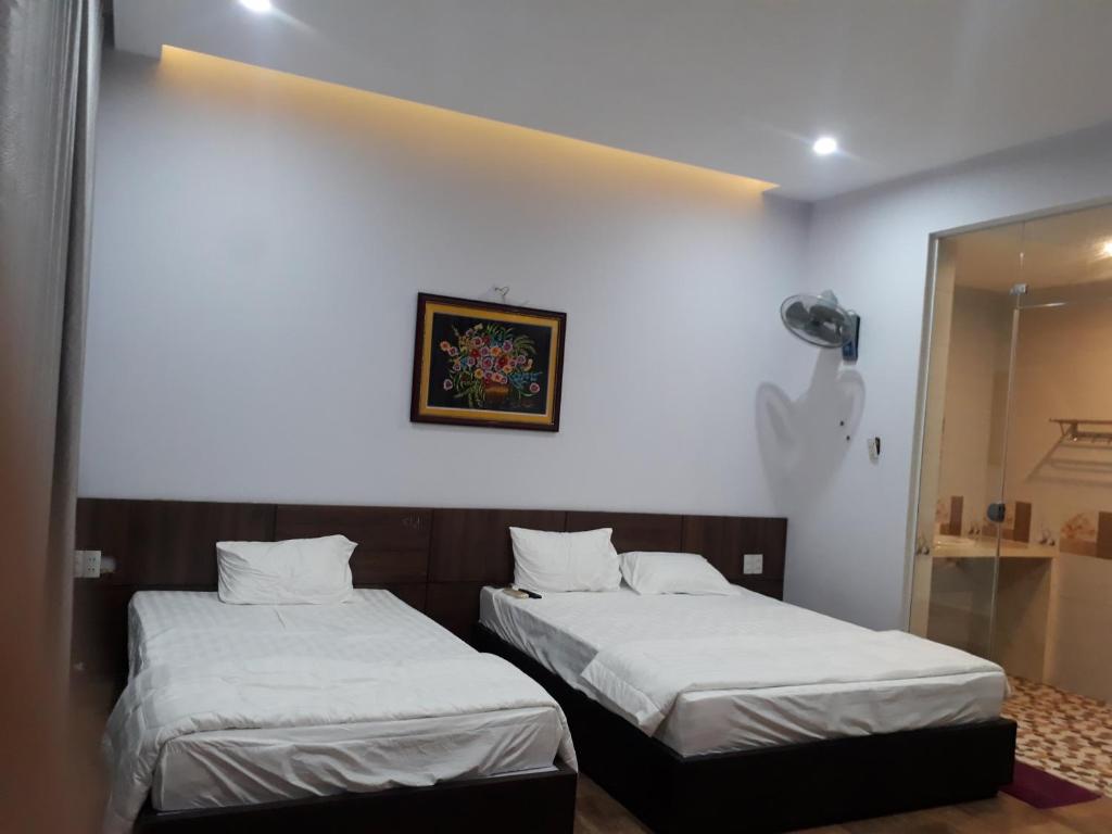 Postel nebo postele na pokoji v ubytování Nhà Nghỉ Việt Thương