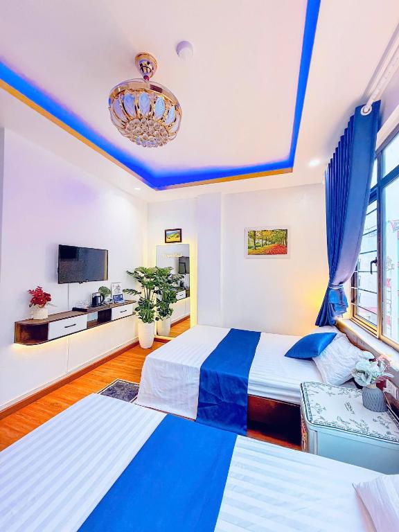 カットバ島にあるVENUS HOTEL catbaのベッド2台と薄型テレビ付きのベッドルーム