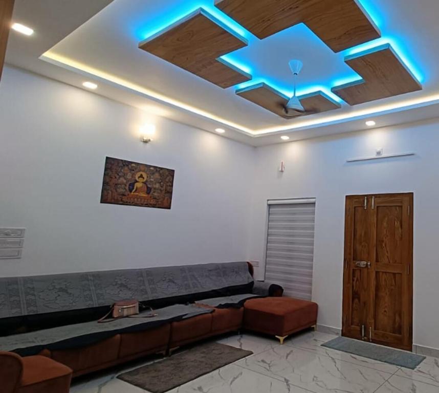 a room with a couch and a ceiling with blue lights at Premium 4 Bedroom Villa in Kannur in Edakkād
