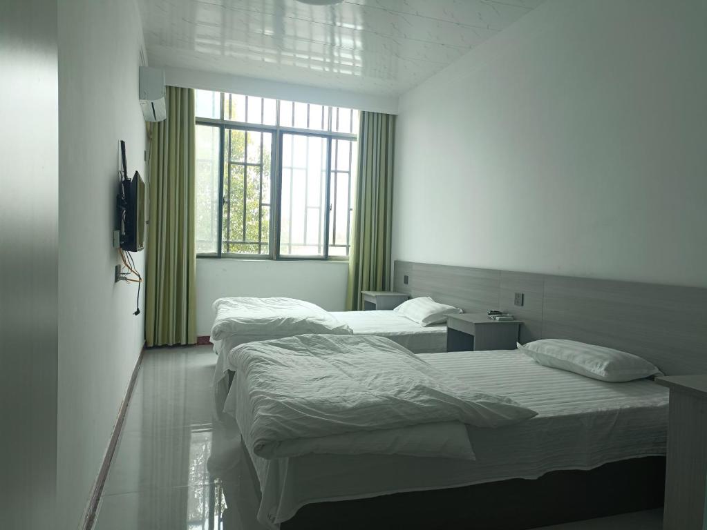 Postel nebo postele na pokoji v ubytování Heleju Homestay