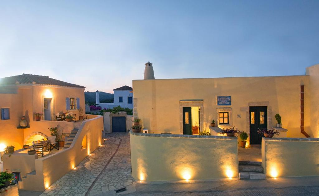 a view of a house at night with lights at Abramis Rooms in Mitáta