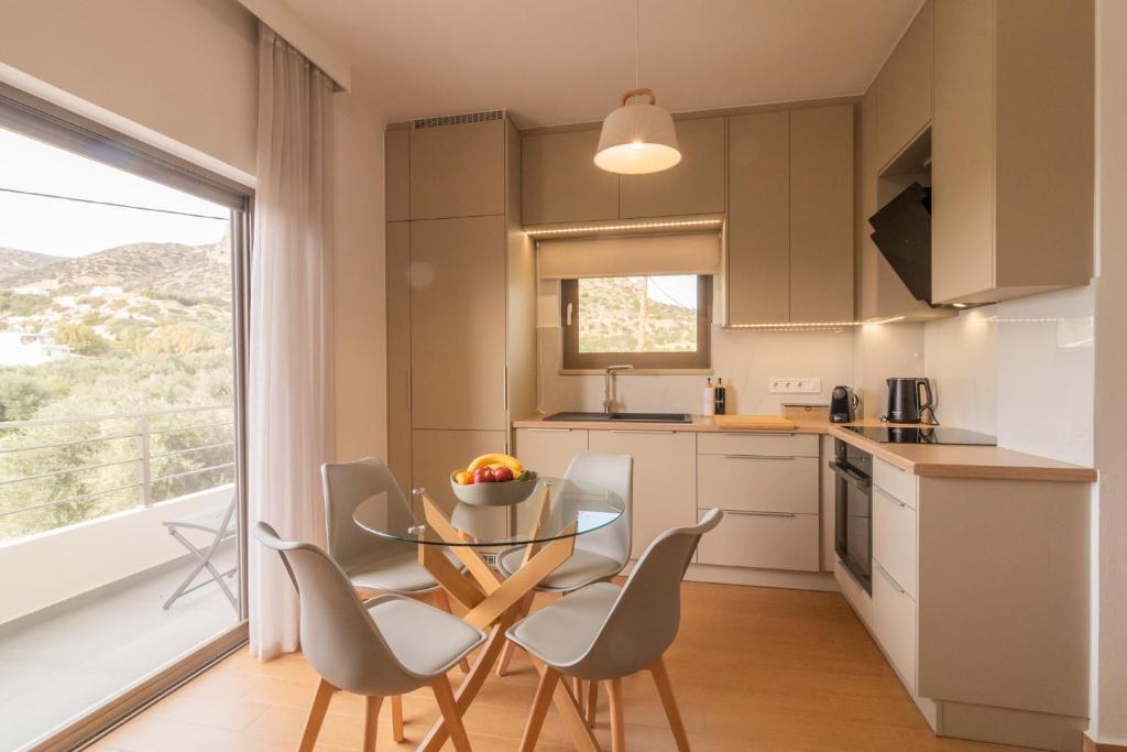 a kitchen with a table and chairs and a window at Diktamo apartment, Palaiochora in Palaiochóra