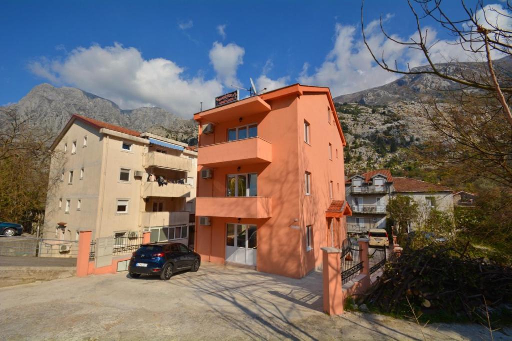 a building with a car parked in front of it at Marinero Apartments in Kotor