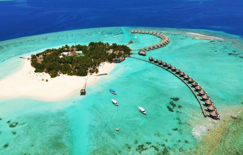 an island in the ocean with a road around it at Thulhagiri Island Resort & Spa in North Male Atoll