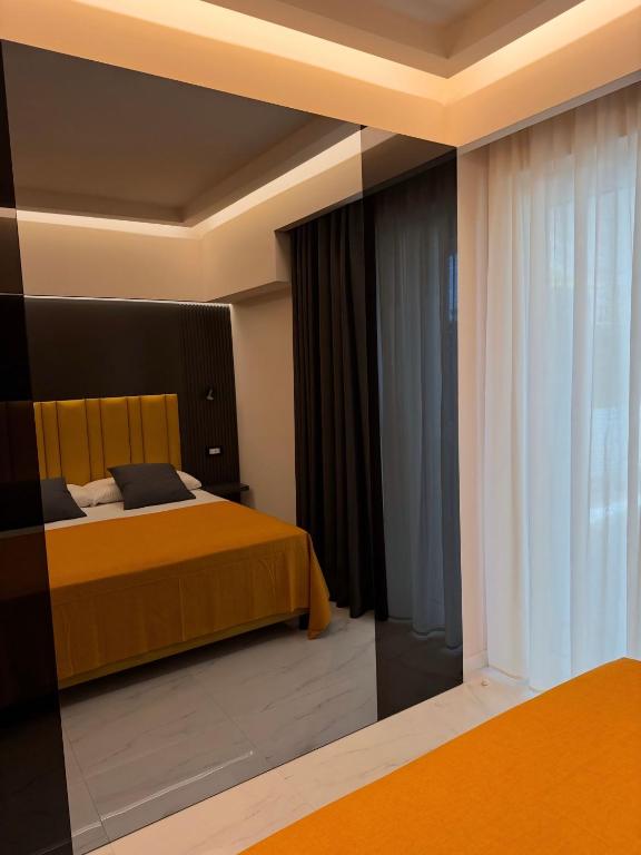 a bedroom with a bed and a large window at Luxury Home Station in Tropea