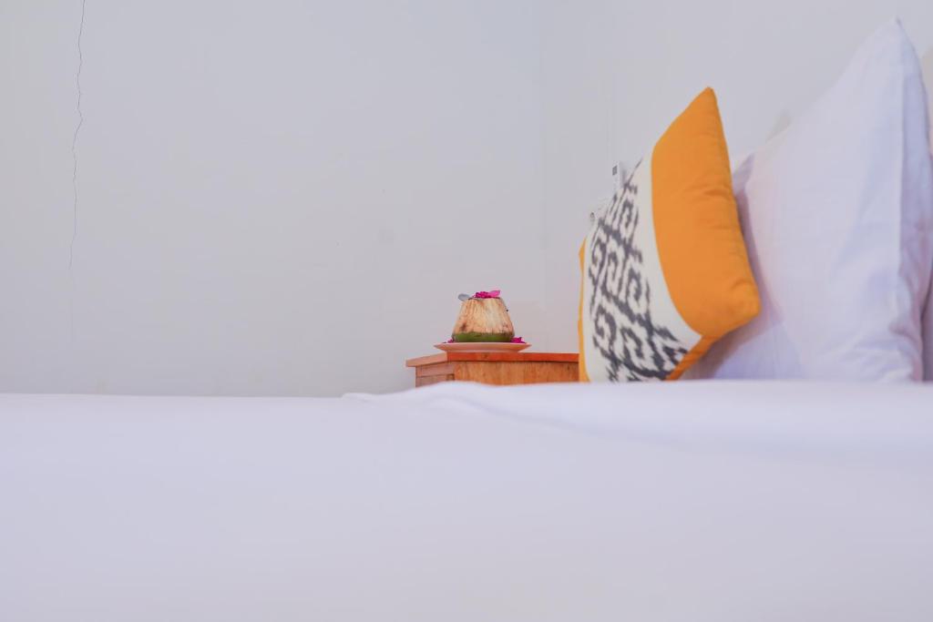 Postel nebo postele na pokoji v ubytování Trytan Gerupuk Homestay