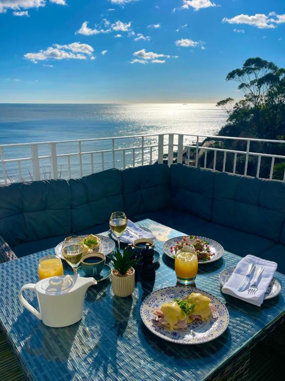 a table with plates of food and glasses of wine at The Wellington Hotel in Ventnor