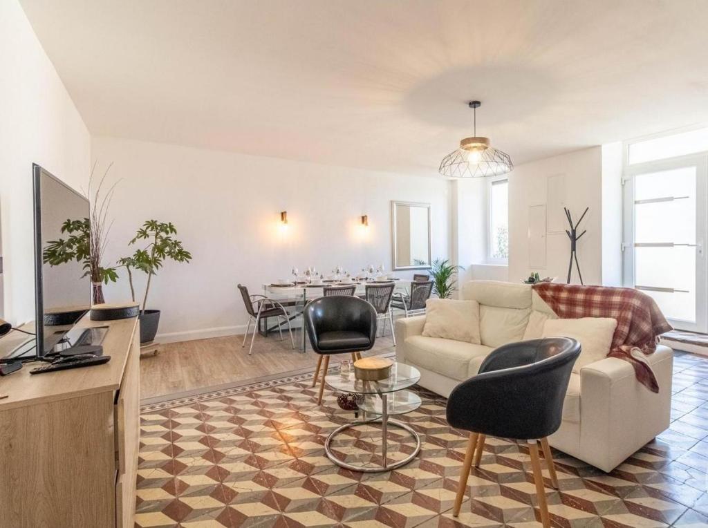 a living room with a couch and a table at Jolie maison Juillan "Une escapade au pied des Pyrénées" in Juillan