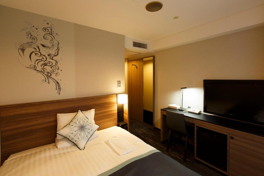 Postel nebo postele na pokoji v ubytování Matsue Excel Hotel Tokyu