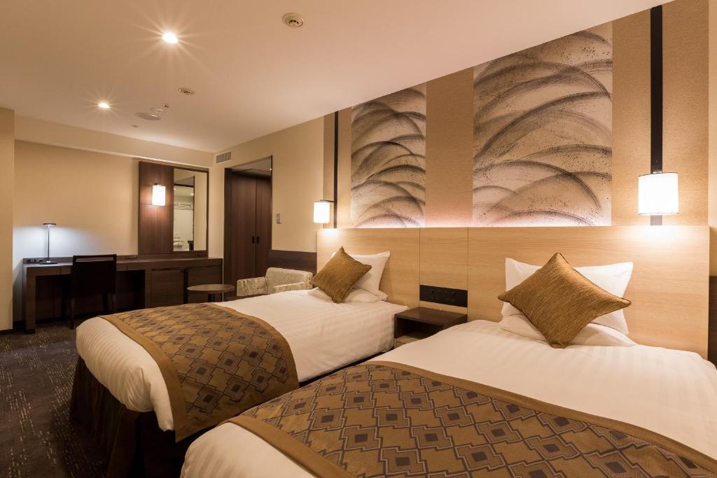 Postel nebo postele na pokoji v ubytování Matsue Excel Hotel Tokyu