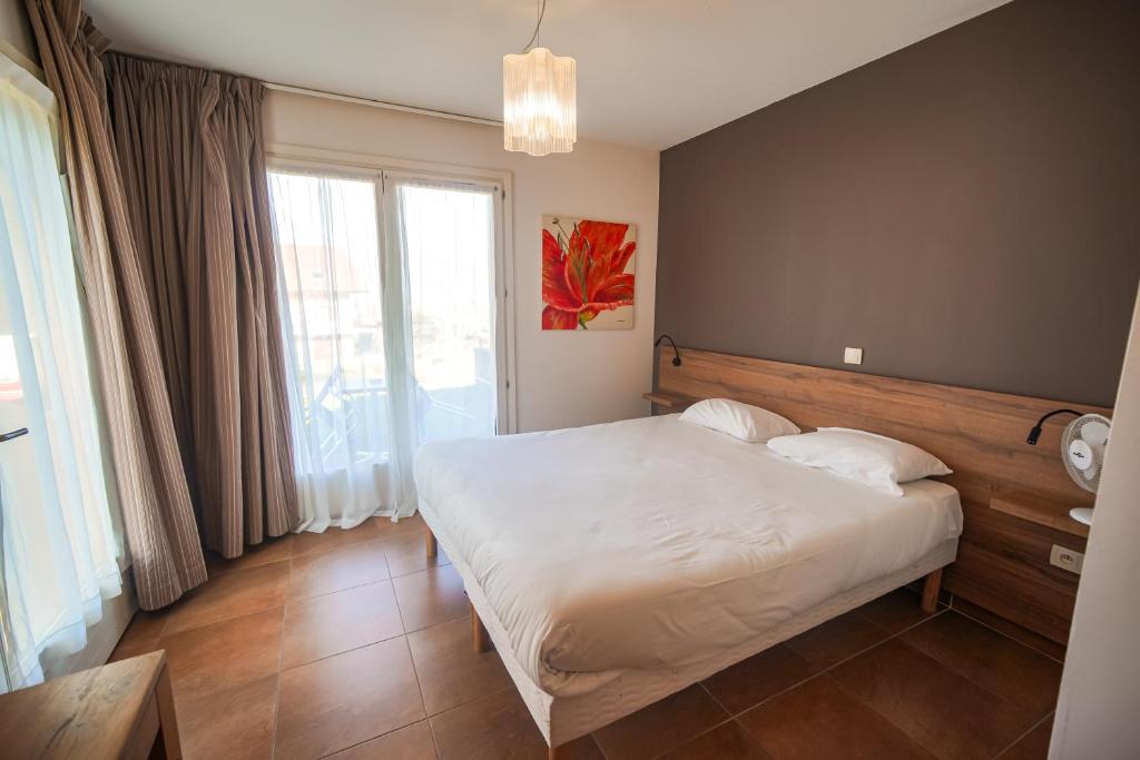 Postel nebo postele na pokoji v ubytování Residence Les Chataigniers