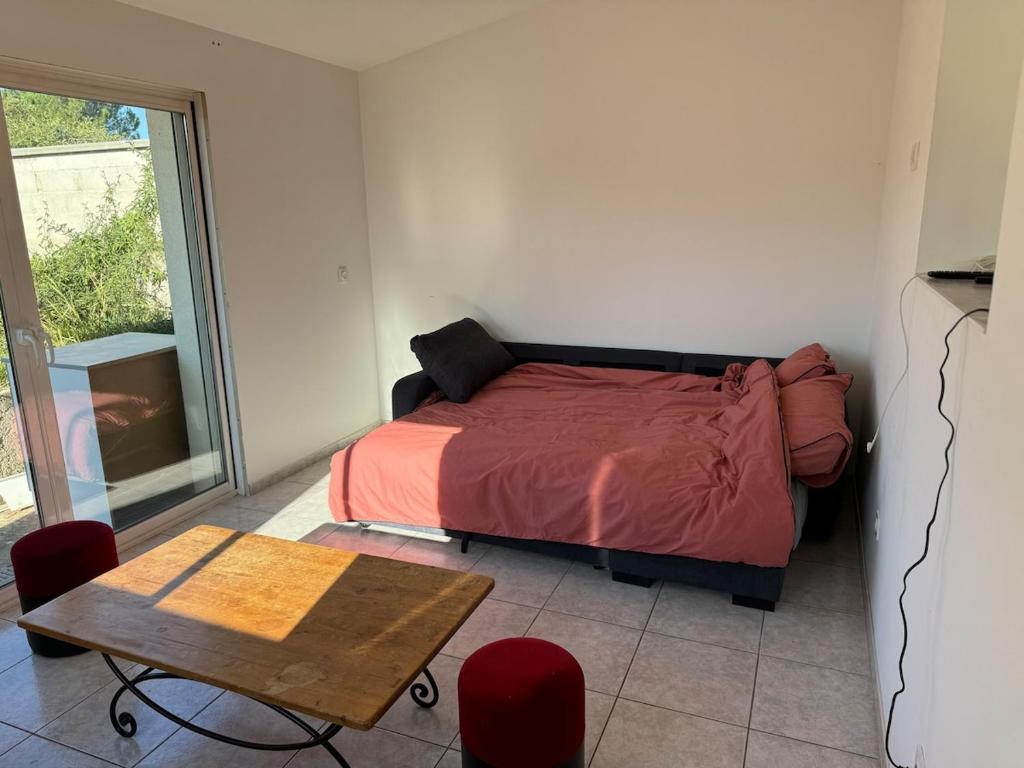 a bedroom with a bed and a table and chairs at Maison in Chatuzange-le-Goubet