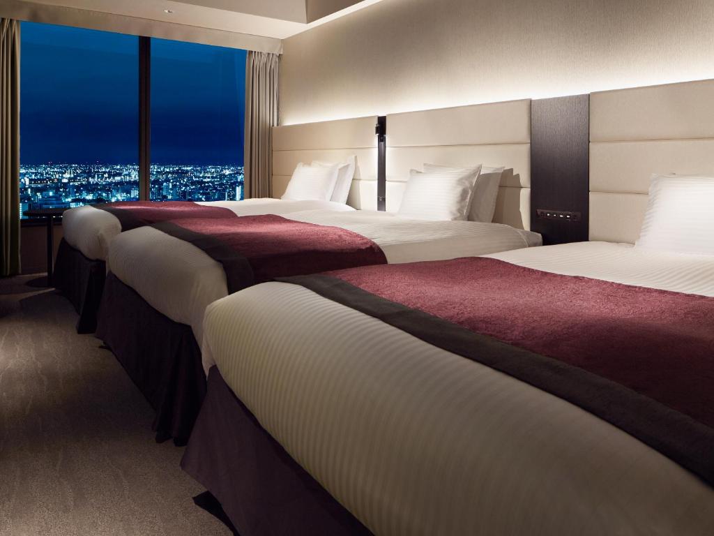 Postel nebo postele na pokoji v ubytování Mitsui Garden Hotel Nagoya Premier