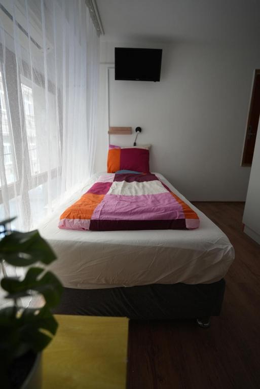 A bed or beds in a room at Center Hostel and Guest House