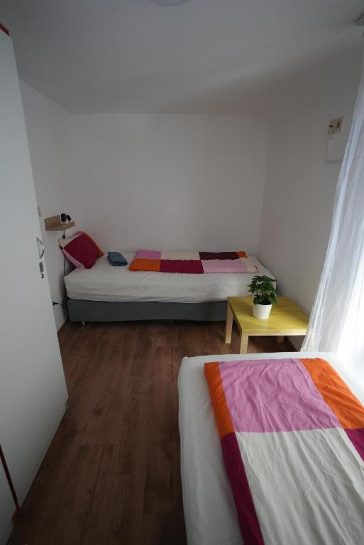 A bed or beds in a room at Center Hostel and Guest House