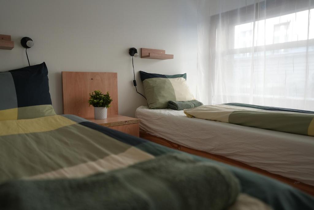 A bed or beds in a room at Center Hostel and Guest House
