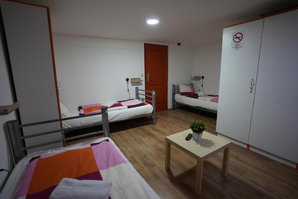 A bed or beds in a room at Center Hostel and Guest House