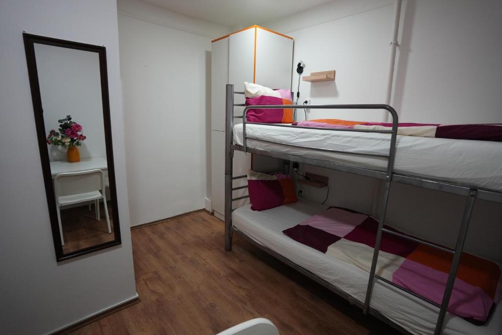 A bed or beds in a room at Center Hostel and Guest House
