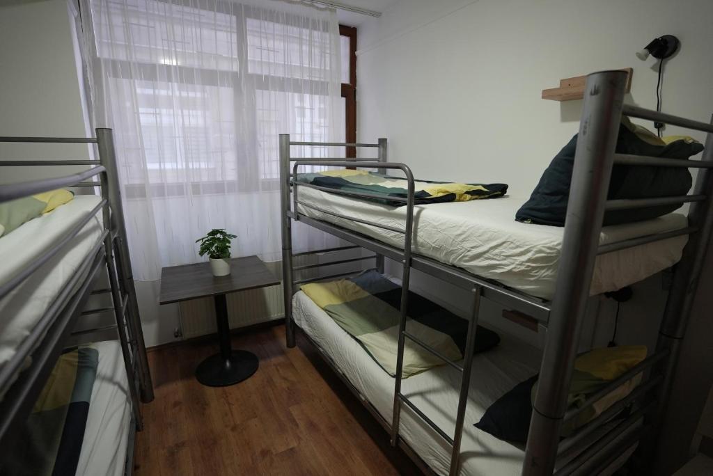 A bed or beds in a room at Center Hostel and Guest House