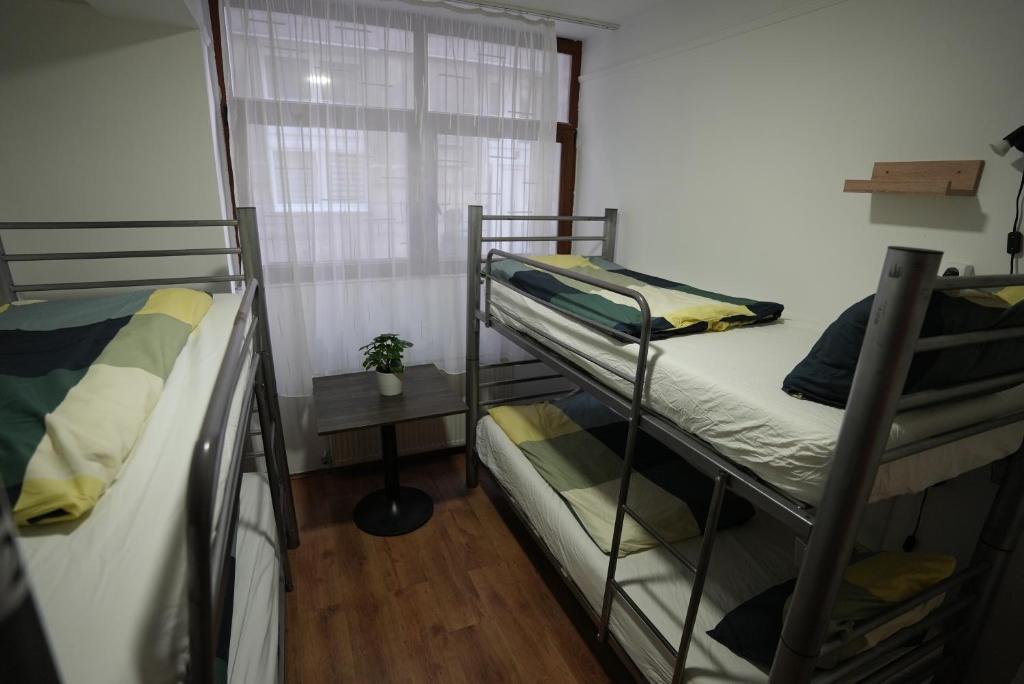 A bed or beds in a room at Center Hostel and Guest House