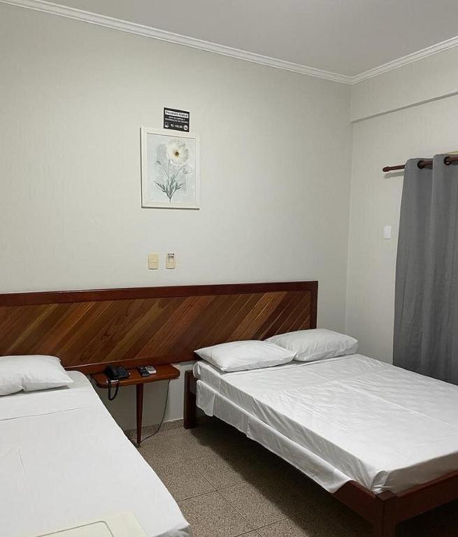 Postel nebo postele na pokoji v ubytování Mariachis Hotel
