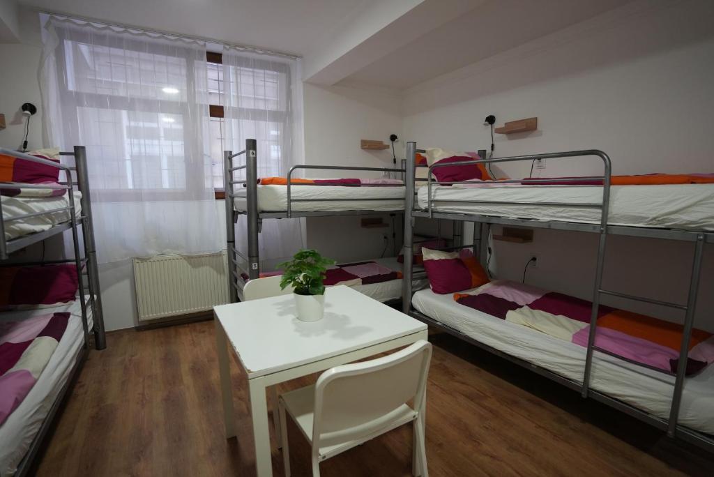 A bed or beds in a room at Center Hostel and Guest House