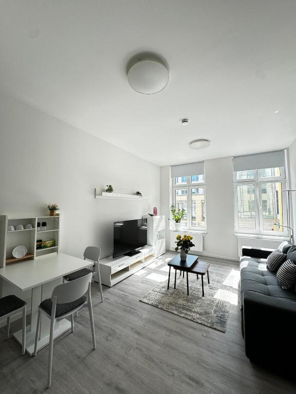 a living room with a couch and a table at Modernes Apartment am Marienplatz, Schwerin in Schwerin