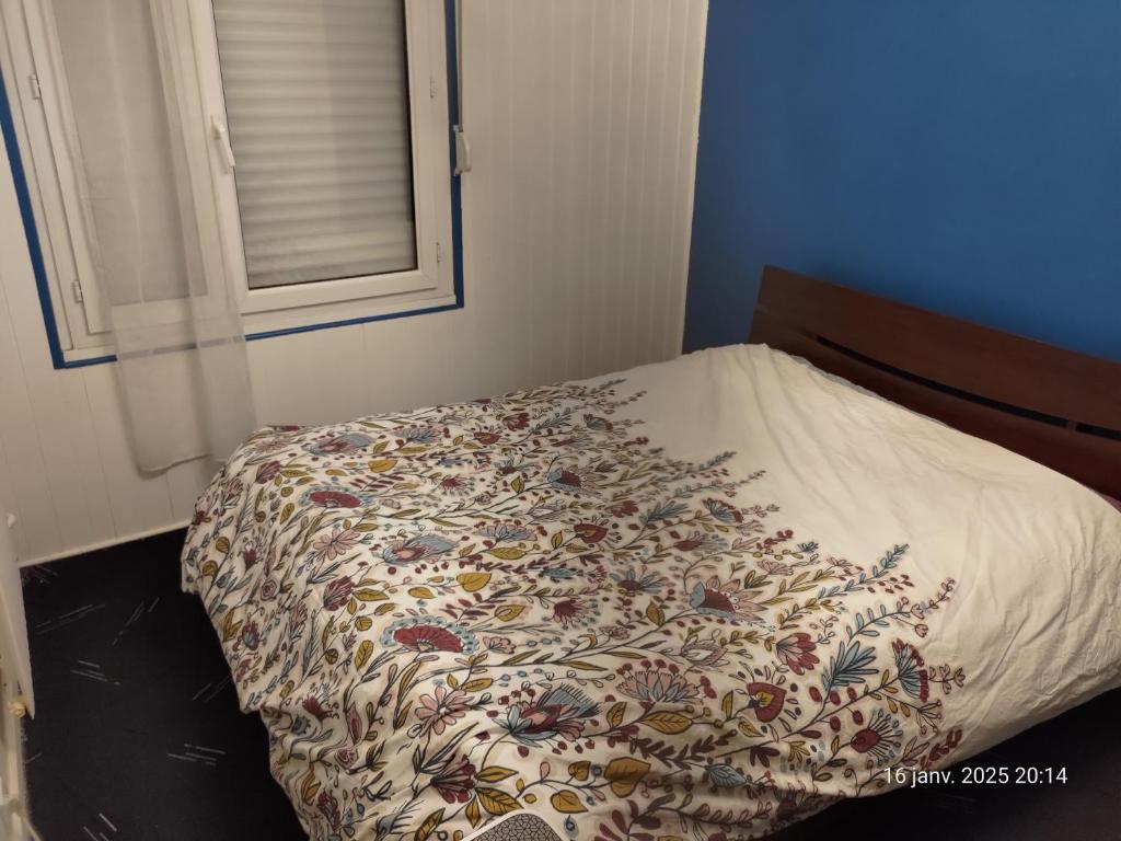 a bed in a bedroom with a blanket on it at Chambre à louer à saint-herblain in Saint-Herblain