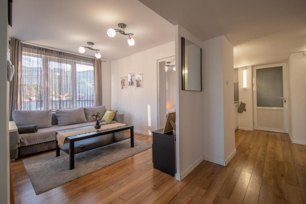 ein Wohnzimmer mit Sofa und Tisch in der Unterkunft Hyggemate - 1 Bed Room Cozy Apartment in Sarnitsa in Sarnitsa